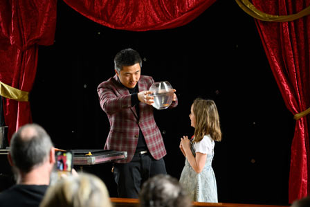 man doing magic with a bowl of water in hands