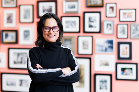 lady standing in front of picture frames