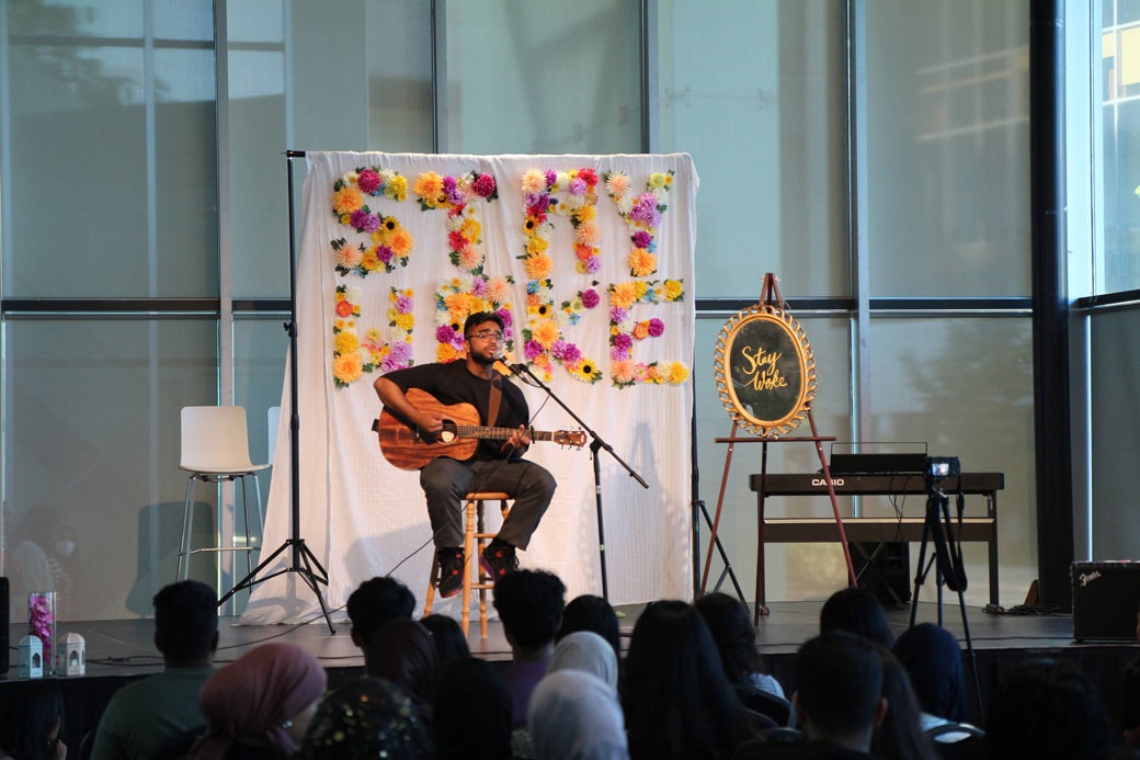 man playing guitar on stage