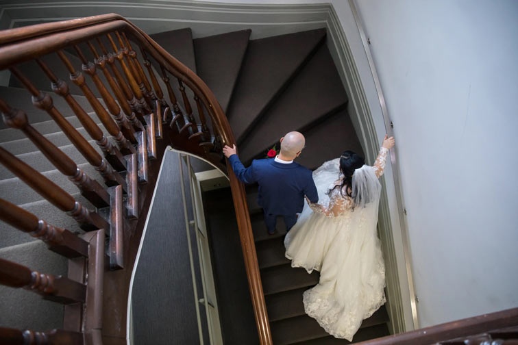 bride and groom walking up stairs