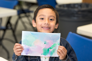 A child holding a painting