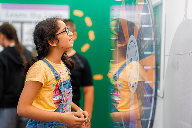 A girl looking at a Spin the wheel game