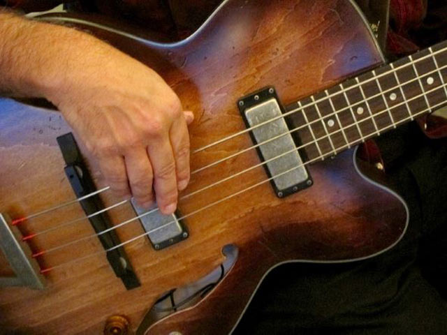 musician stringing a guitar