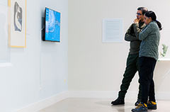 two gallery attendees looking at art