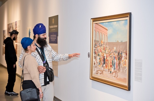 People looking at a painting.