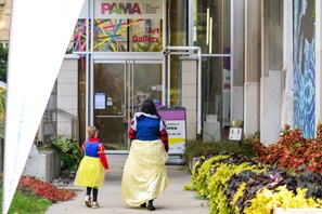 guests entering PAMA dressed in their halloween costumes