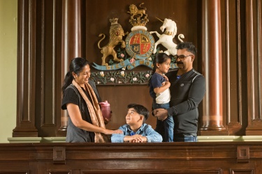A Family standing in the PAMA courthouse