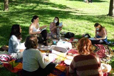 group of people outside sitting on the lawn outdoors